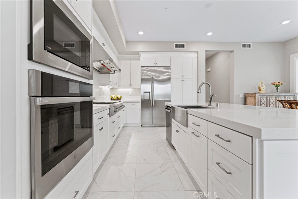 168 Perspective Irvine, CA 92618 - Photo 11 of 49 a kitchen with cabinets stainless steel appliances and sink