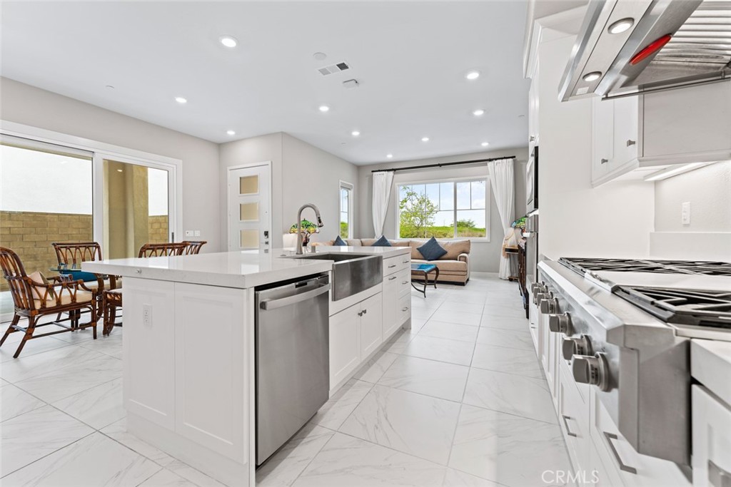 168 Perspective Irvine, CA 92618 - Photo 12 of 49 a kitchen with a sink stove and chairs