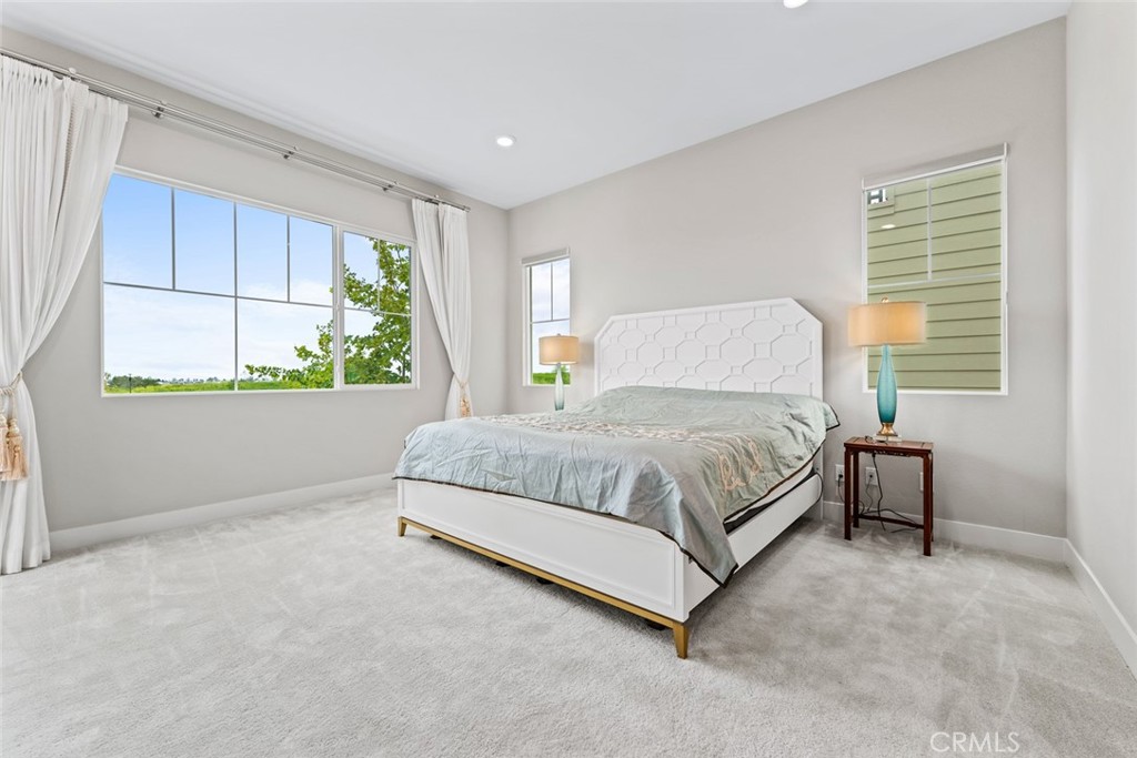 168 Perspective Irvine, CA 92618 - Photo 15 of 49 a bedroom with a bed lamp and window