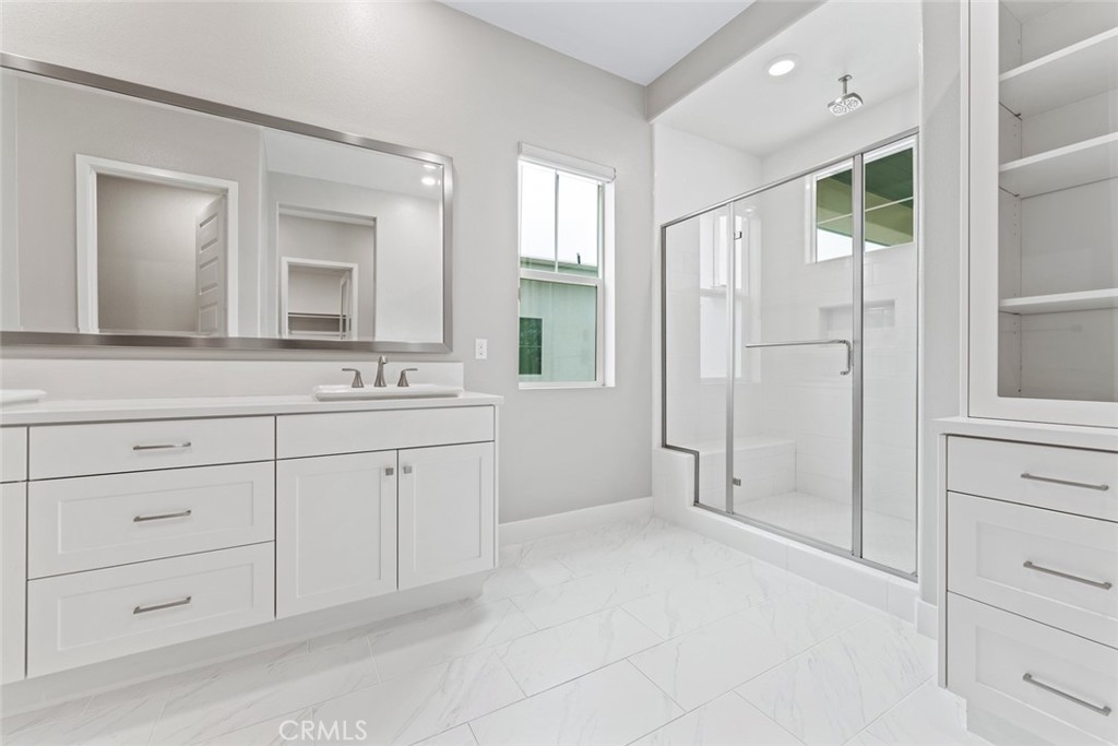 168 Perspective Irvine, CA 92618 - Photo 19 of 49 a spacious bathroom with a shower a sink and a mirror