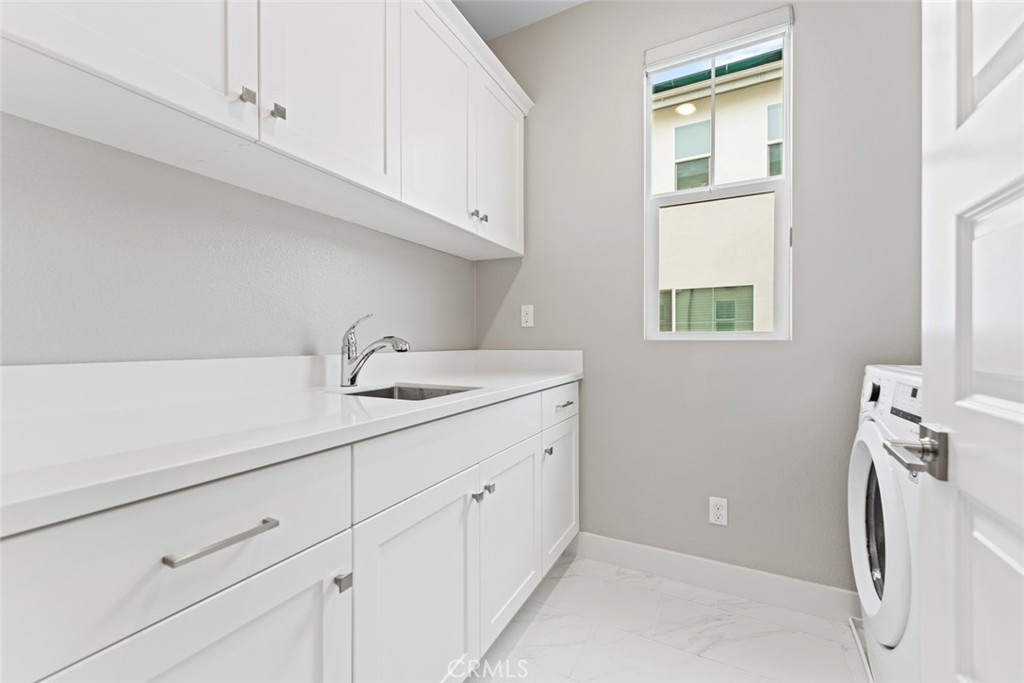 168 Perspective Irvine, CA 92618 - Photo 22 of 49 a utility room with cabinets washer and dryer