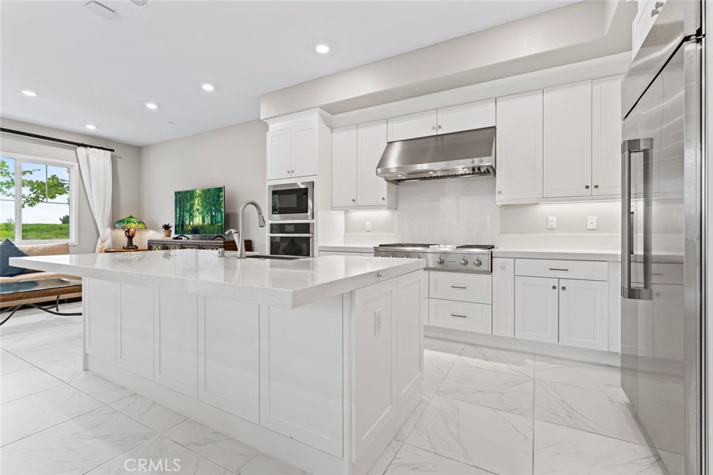 168 Perspective Irvine, CA 92618 - Photo 3 of 49 a kitchen with white cabinets and appliances