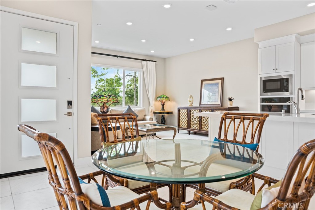 168 Perspective Irvine, CA 92618 - Photo 6 of 49 a dining room with furniture a window and wooden floor