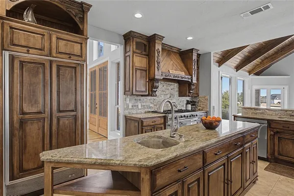 a kitchen with stainless steel appliances granite countertop a stove and a sink