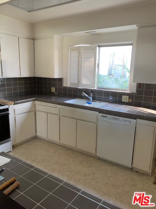2425 Crest View Drive Los Angeles, CA 90046 - Photo 6 of 14 a kitchen with a sink and cabinets