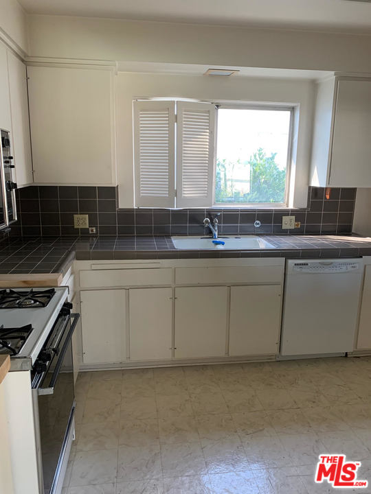 2425 Crest View Drive Los Angeles, CA 90046 - Photo 7 of 14 a kitchen with stainless steel appliances granite countertop a sink a stove and a refrigerator