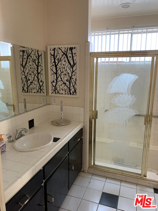 2425 Crest View Drive Los Angeles, CA 90046 - Photo 9 of 14 a bathroom with a sink and a mirror
