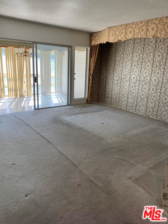 2425 Crest View Drive Los Angeles, CA 90046 - Photo 10 of 14 a view of hallway with windows and chandelier
