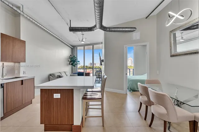 a kitchen with a table chairs refrigerator and cabinets