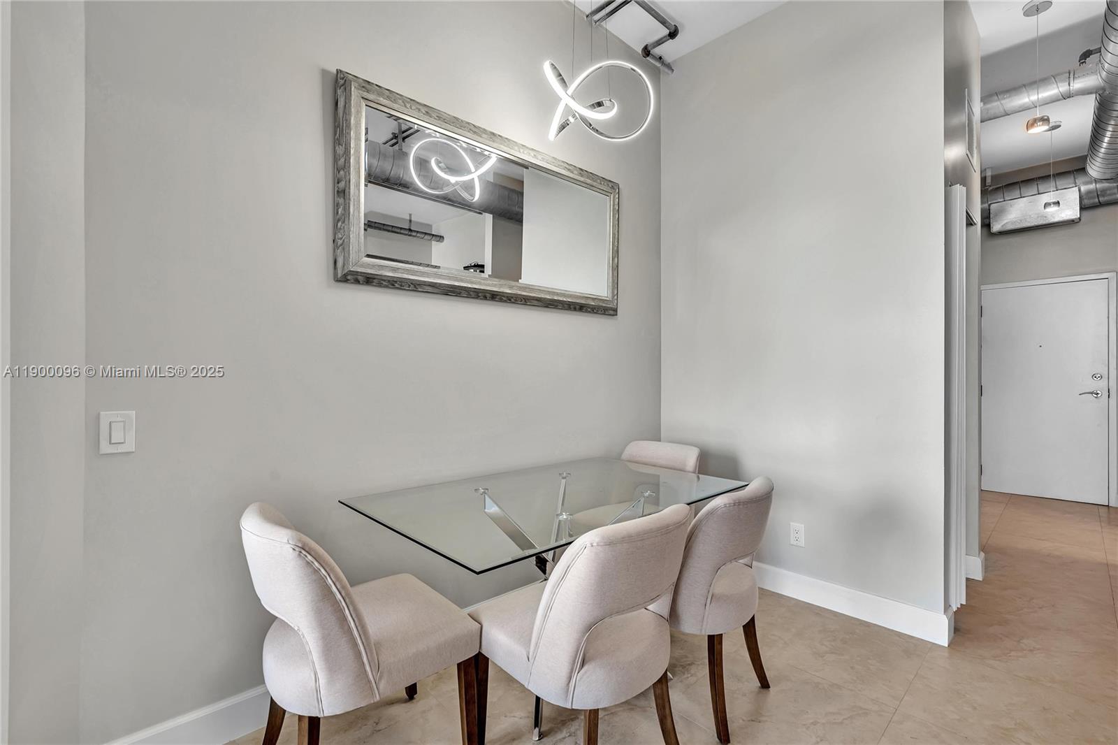 3029 Northeast 188th Street, Unit 503 Aventura, FL 33180 - Photo 16 of 60 a view of a dining room with furniture and a chandelier