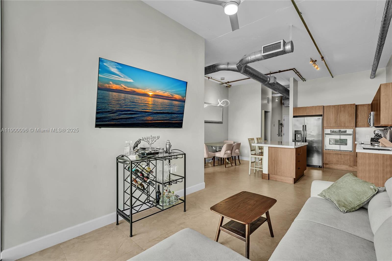 3029 Northeast 188th Street, Unit 503 Aventura, FL 33180 - Photo 18 of 60 a living room with furniture and a flat screen tv