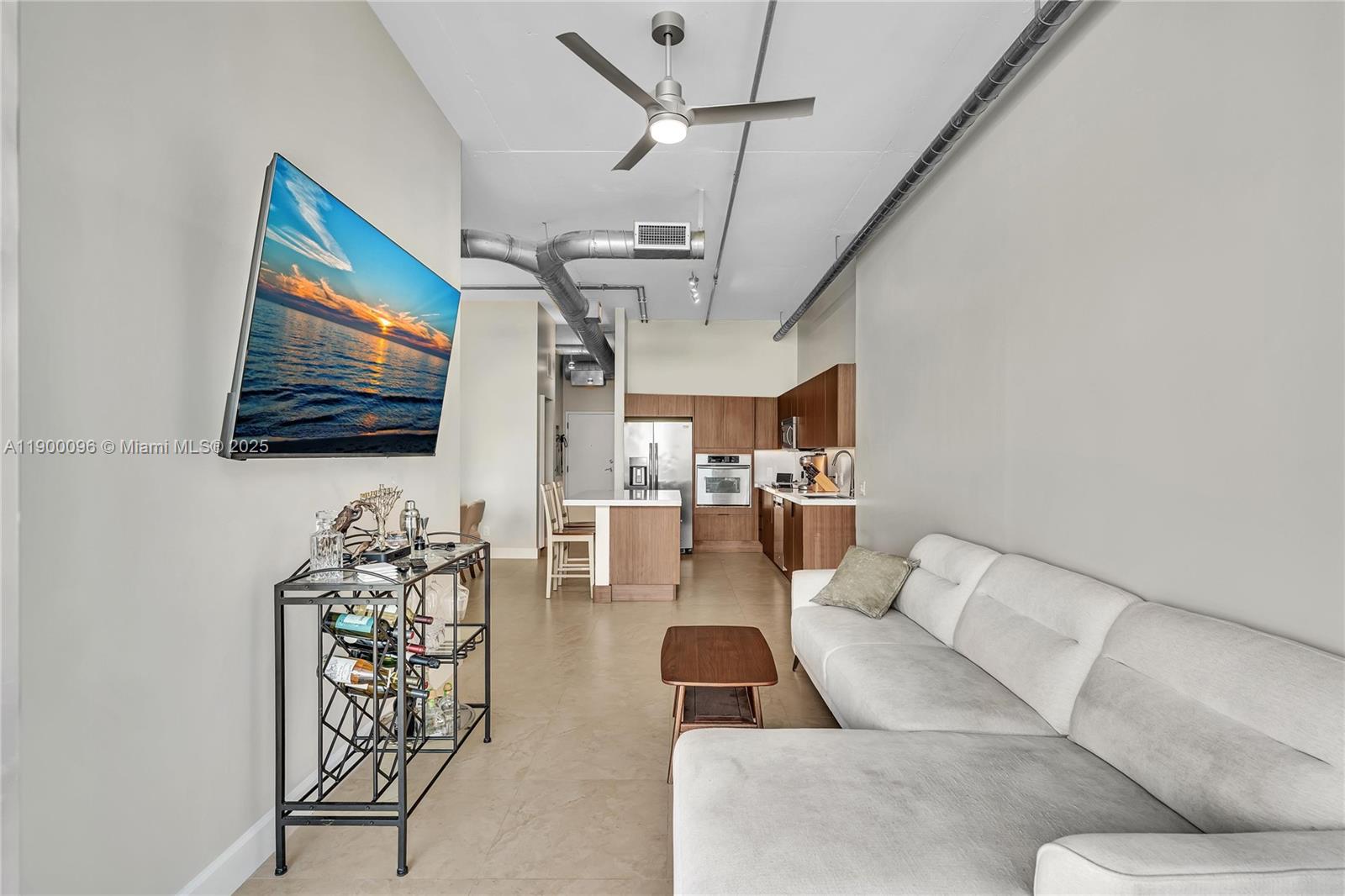 3029 Northeast 188th Street, Unit 503 Aventura, FL 33180 - Photo 26 of 60 a living room with furniture and a flat screen tv