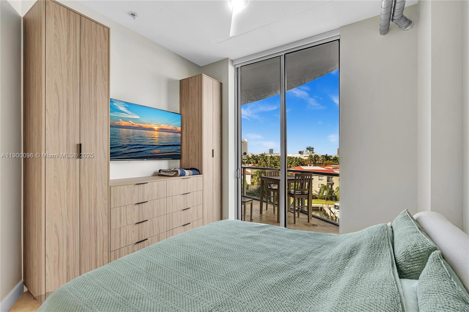 3029 Northeast 188th Street, Unit 503 Aventura, FL 33180 - Photo 29 of 60 a bedroom with a bed and a flat screen tv