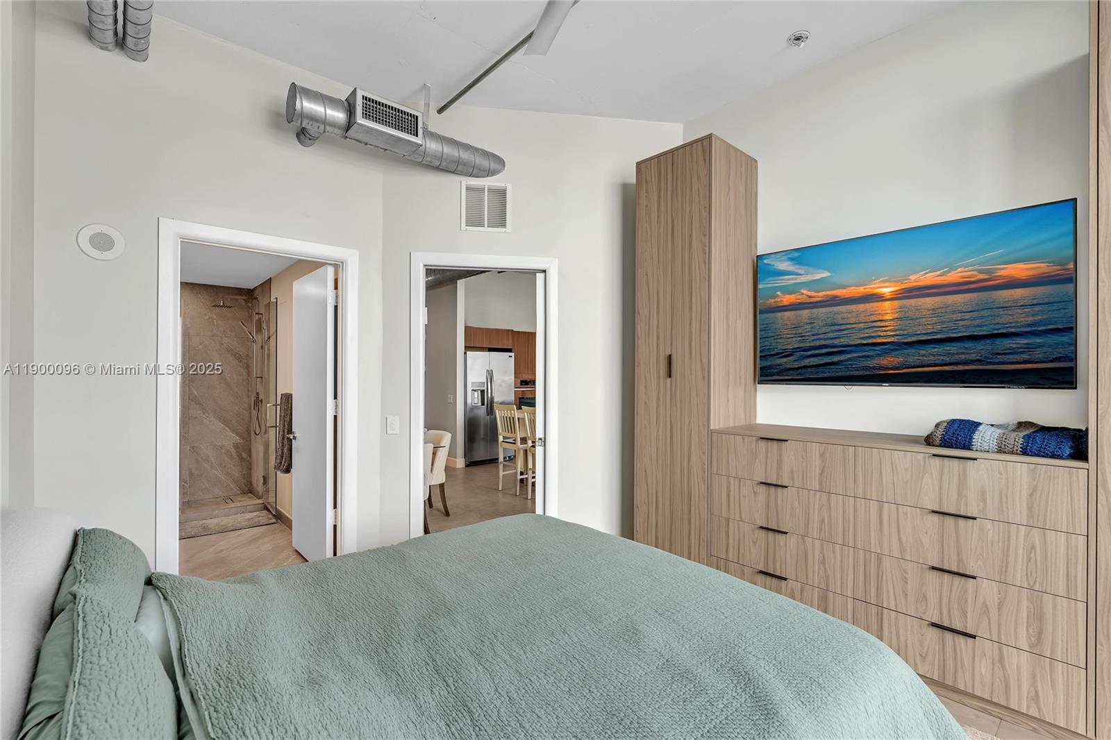 3029 Northeast 188th Street, Unit 503 Aventura, FL 33180 - Photo 30 of 60 a bedroom with a bed and a flat screen tv