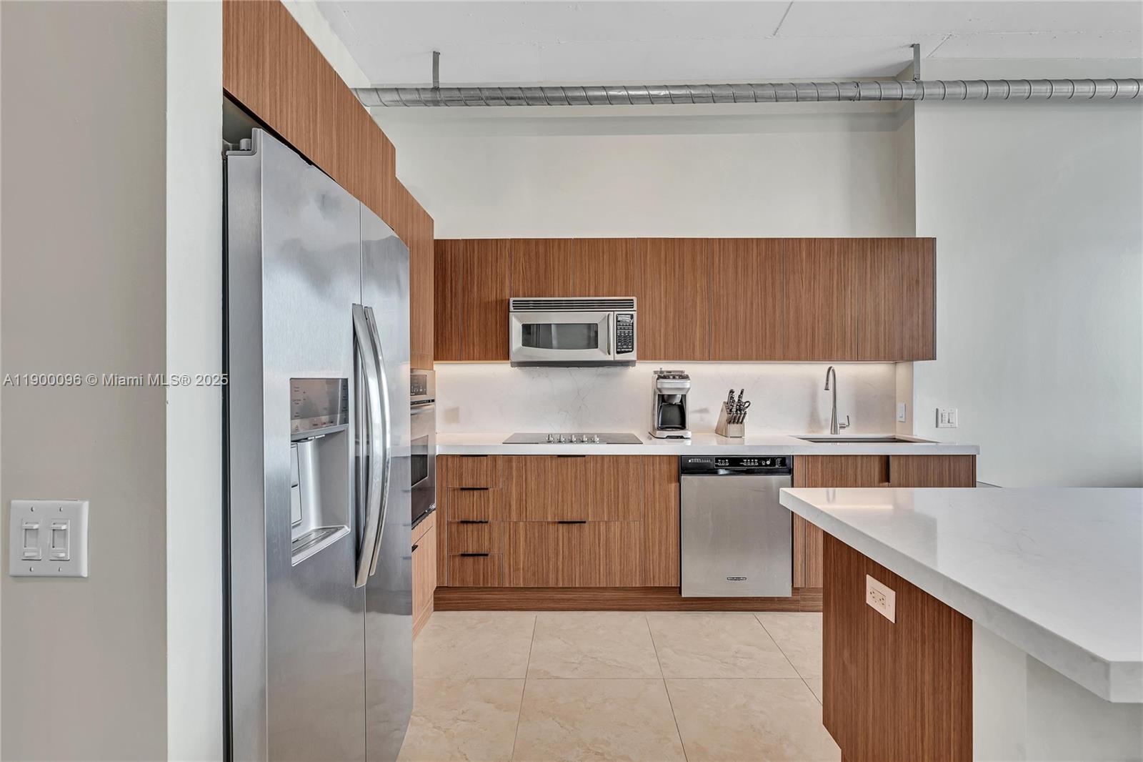 3029 Northeast 188th Street, Unit 503 Aventura, FL 33180 - Photo 3 of 60 a kitchen with stainless steel appliances granite countertop a refrigerator and a stove top oven