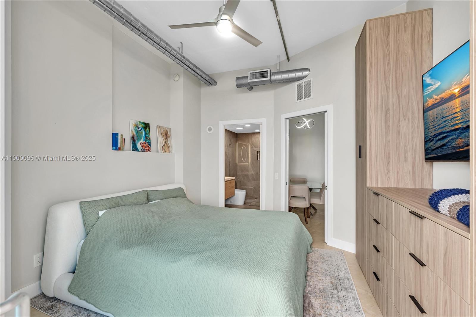 3029 Northeast 188th Street, Unit 503 Aventura, FL 33180 - Photo 31 of 60 a bedroom with a bed and a flat tv screen on dresser