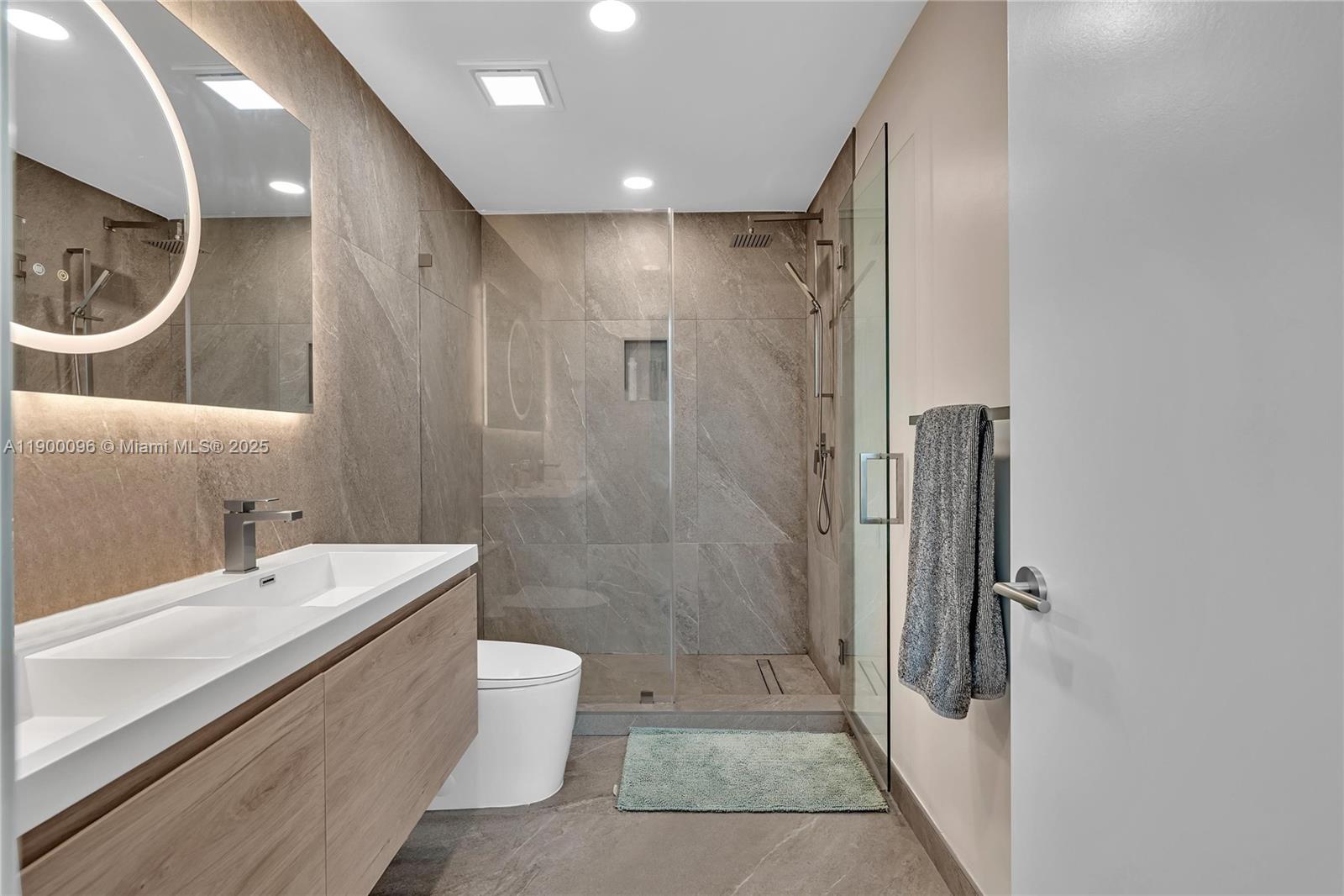 3029 Northeast 188th Street, Unit 503 Aventura, FL 33180 - Photo 33 of 60 a bathroom with a bathtub shower sink and toilet