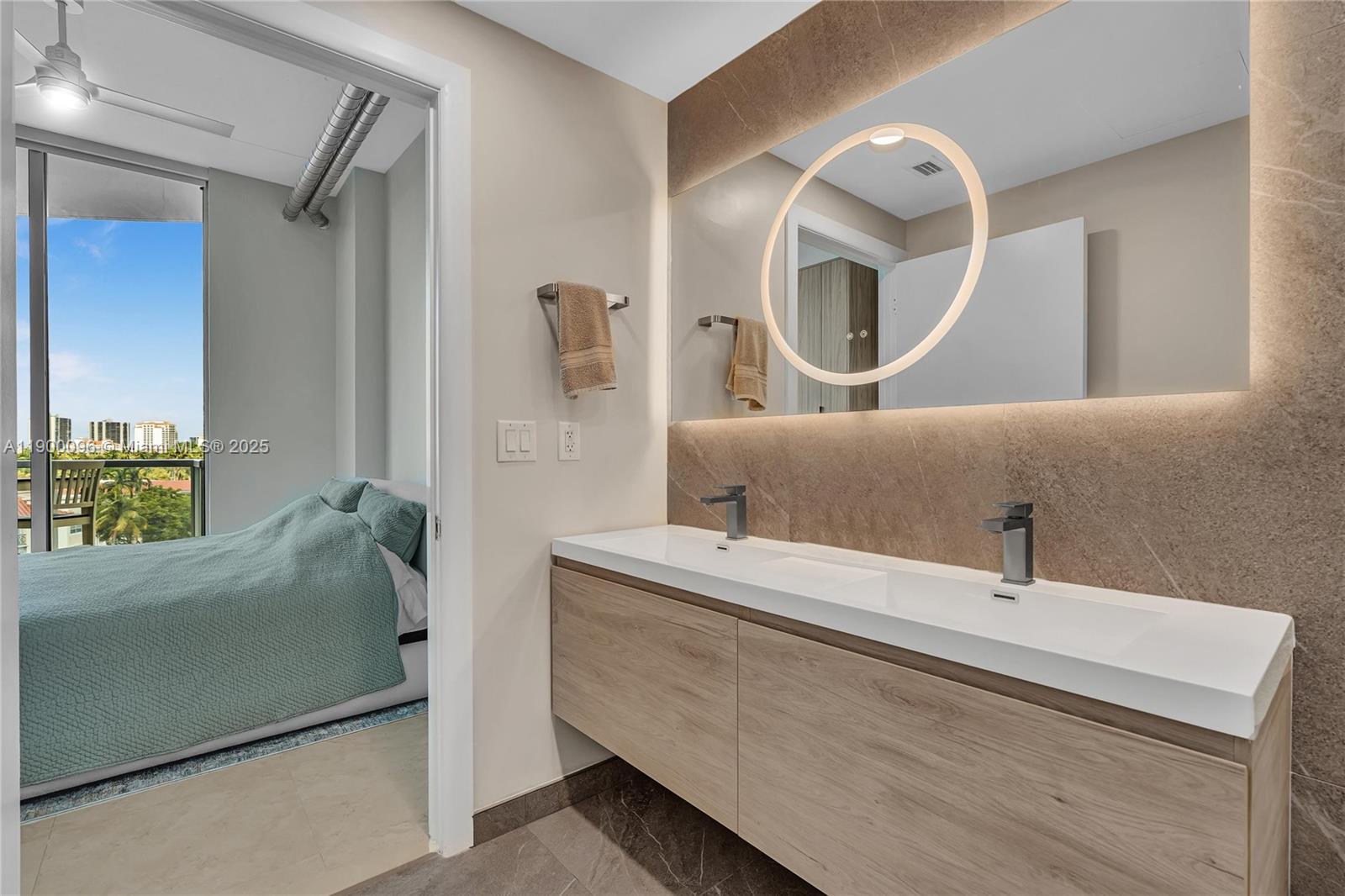 3029 Northeast 188th Street, Unit 503 Aventura, FL 33180 - Photo 34 of 60 a en suite bathroom with a double vanity sink and mirror