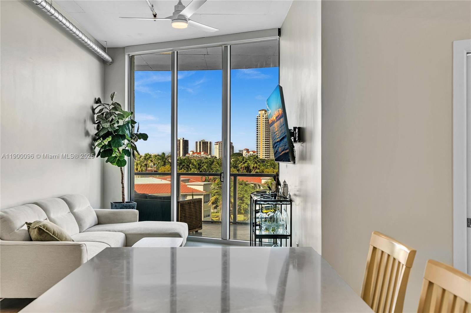 3029 Northeast 188th Street, Unit 503 Aventura, FL 33180 - Photo 4 of 60 a living room with furniture and potted plant