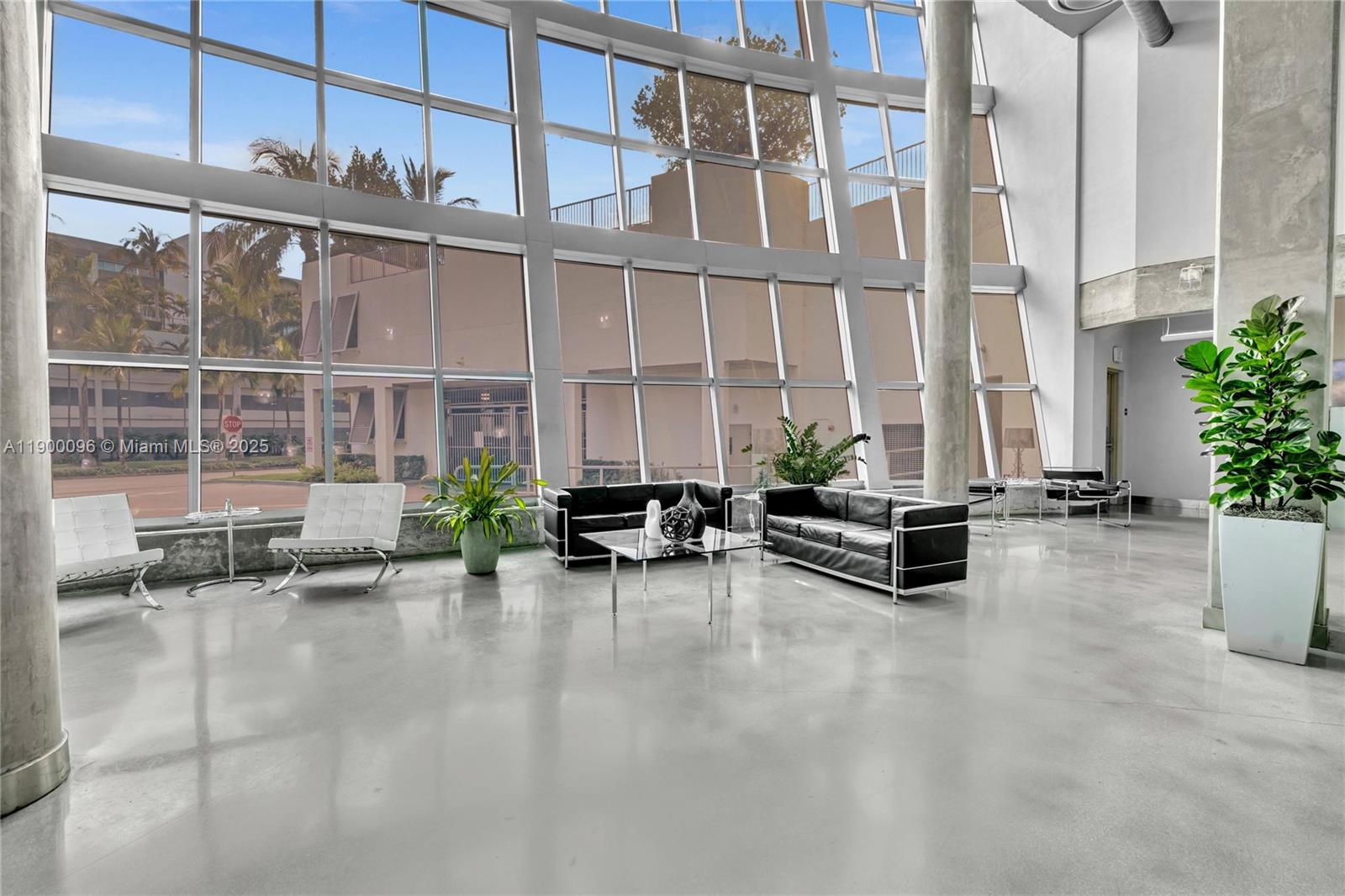 3029 Northeast 188th Street, Unit 503 Aventura, FL 33180 - Photo 41 of 60 a view of a patio with a table and chairs and potted plants