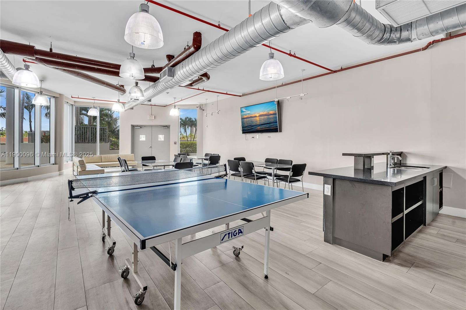 3029 Northeast 188th Street, Unit 503 Aventura, FL 33180 - Photo 49 of 60 a kitchen with stainless steel appliances granite countertop a sink counter space and wooden floors