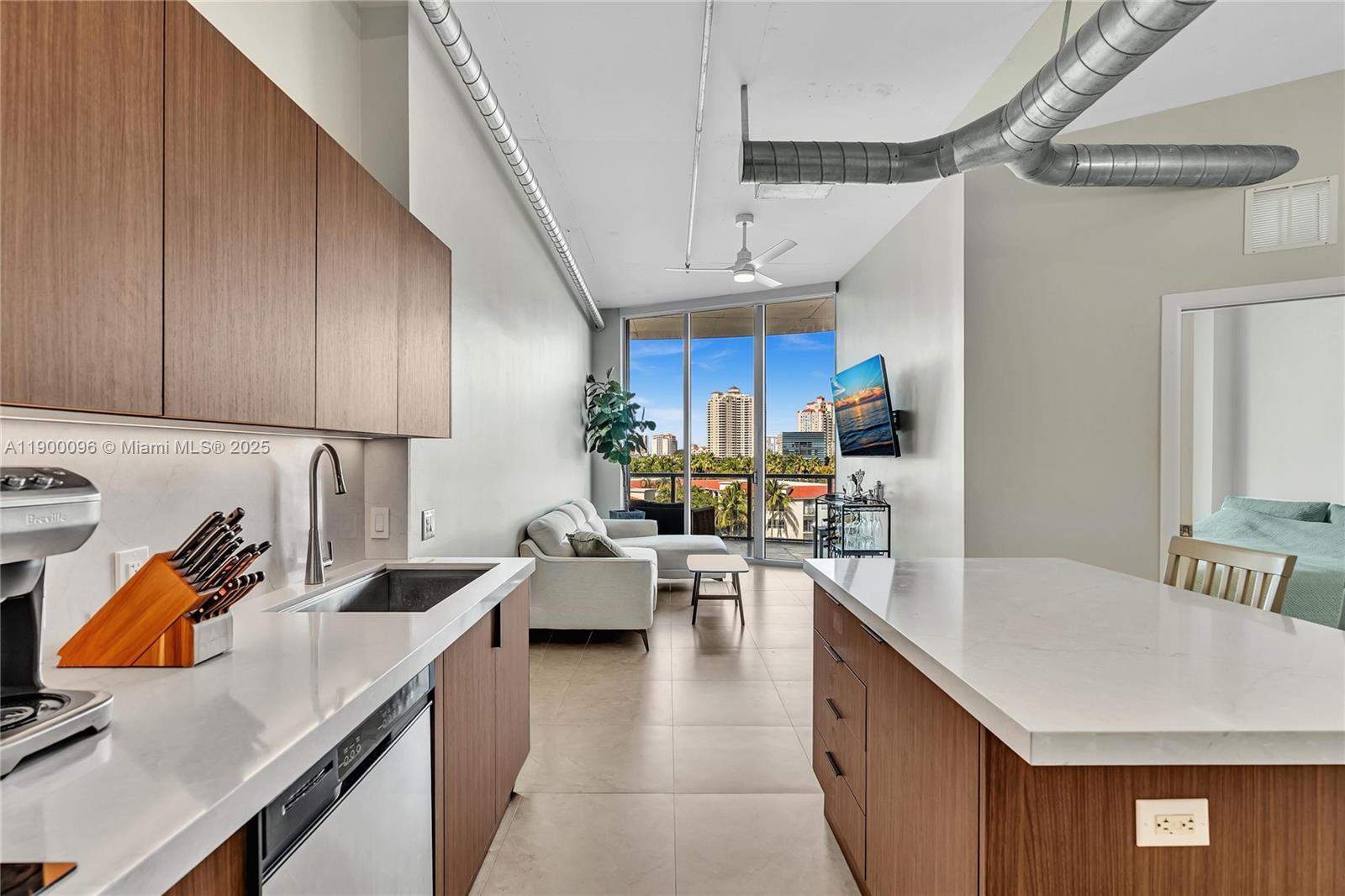 3029 Northeast 188th Street, Unit 503 Aventura, FL 33180 - Photo 6 of 60 a kitchen with stainless steel appliances granite countertop a sink dishwasher stove top oven and cabinets with wooden floor