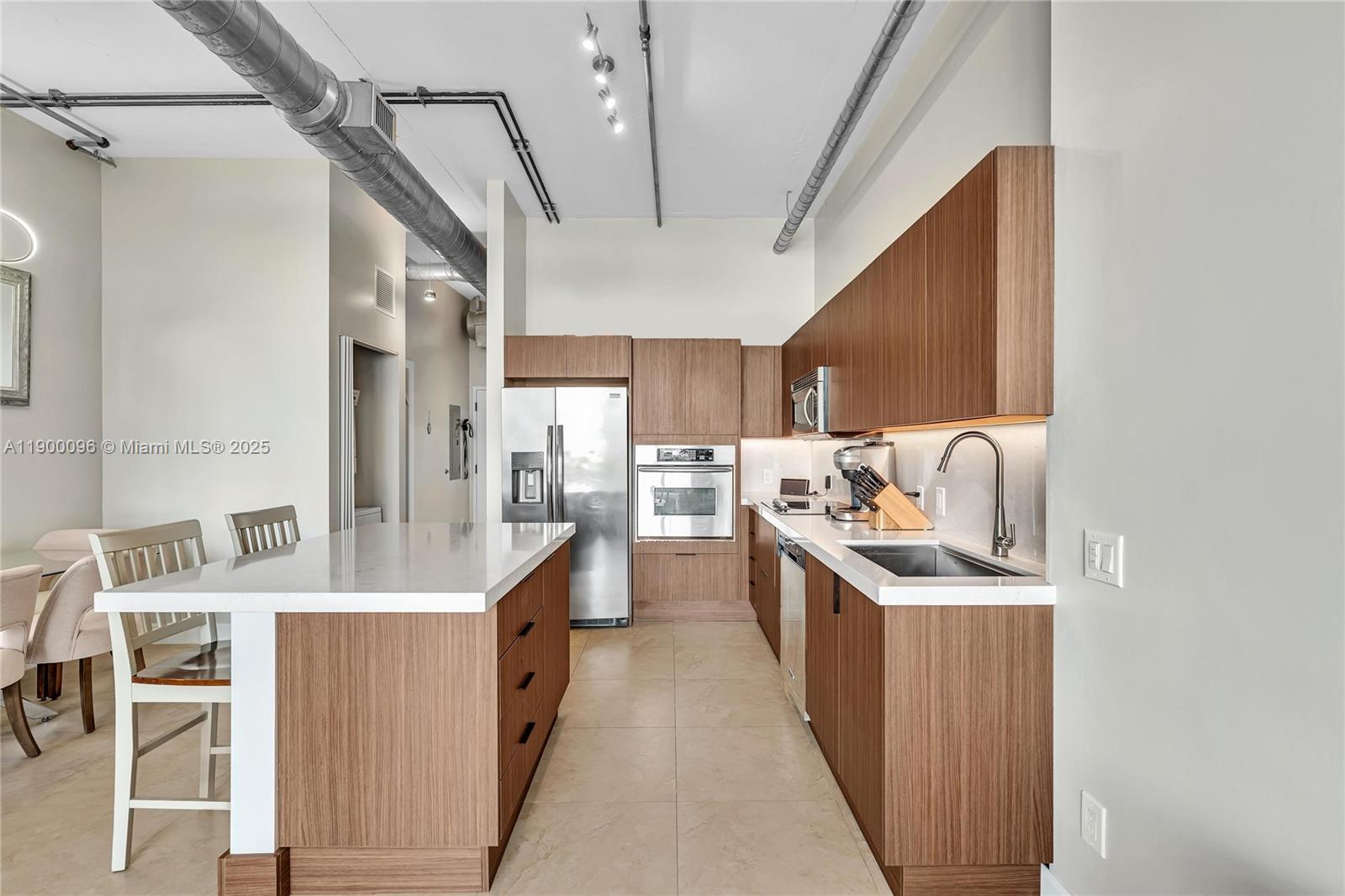 3029 Northeast 188th Street, Unit 503 Aventura, FL 33180 - Photo 7 of 60 a kitchen with stainless steel appliances a sink stove and cabinets