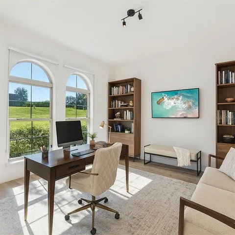 a dining room with furniture a chandelier and wooden floor