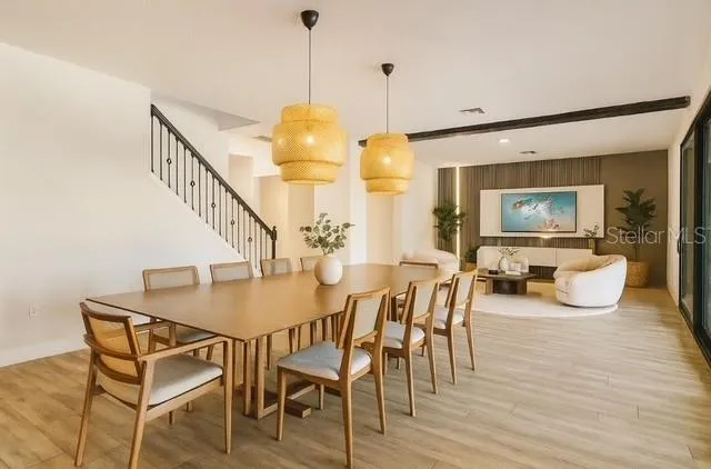 a kitchen with a table chairs refrigerator and cabinets