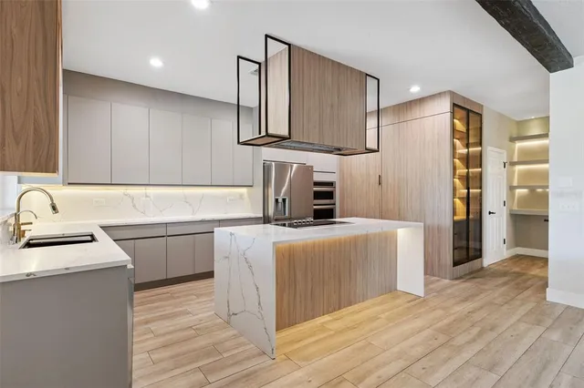 a kitchen with stainless steel appliances granite countertop a sink stove and refrigerator