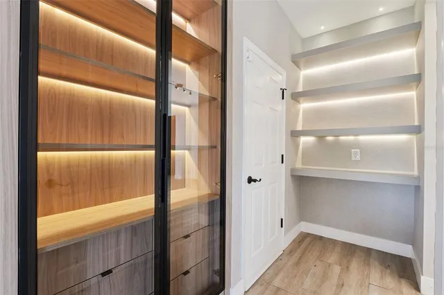 a view of an empty room and wooden floor