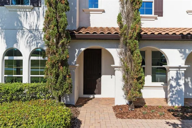 a front view of a house with plants