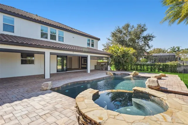 an aerial view of residential house with outdoor space and seating area