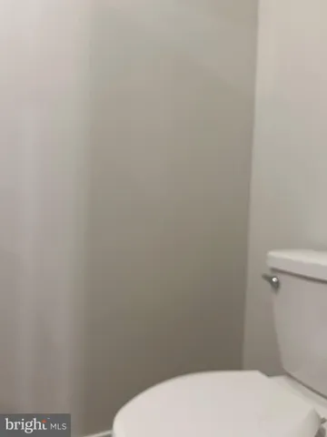 a white toilet sitting in a bathroom