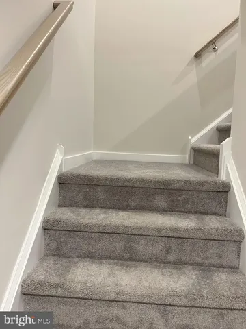 a view of staircase with white walls