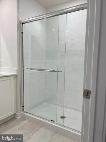 a bathroom with a glass shower door