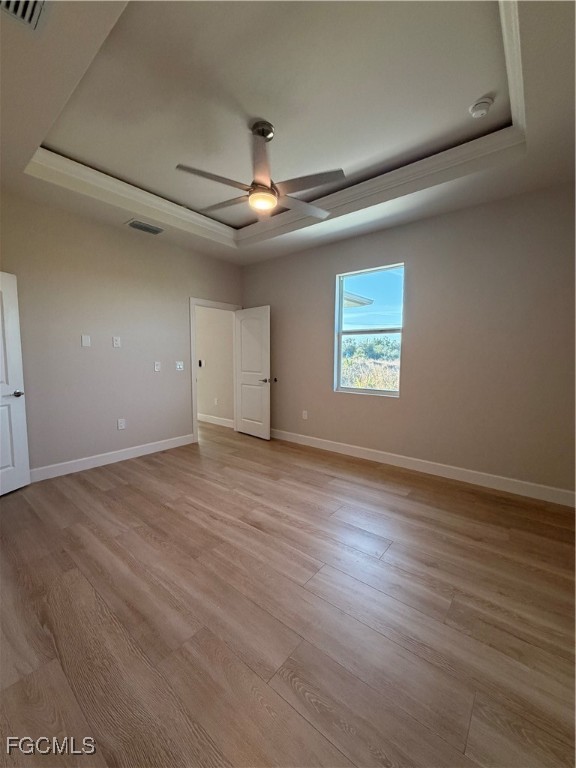 101 Pennfield Street Lehigh Acres, FL 33974 - Photo 13 of 29 an empty room with wooden floor chandelier and windows