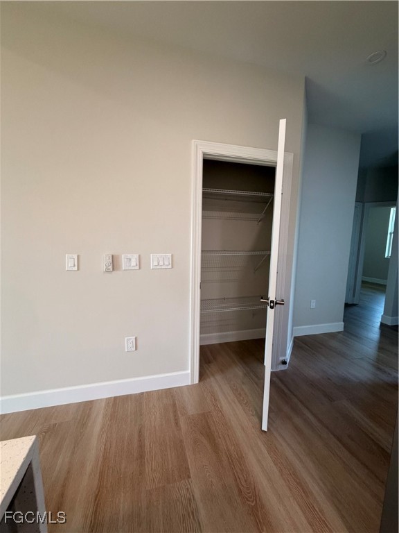 101 Pennfield Street Lehigh Acres, FL 33974 - Photo 16 of 29 an empty room with wooden floor and closet