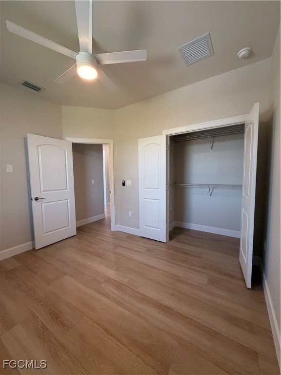 101 Pennfield Street Lehigh Acres, FL 33974 - Photo 20 of 29 a view of an empty room with closet and wooden floor