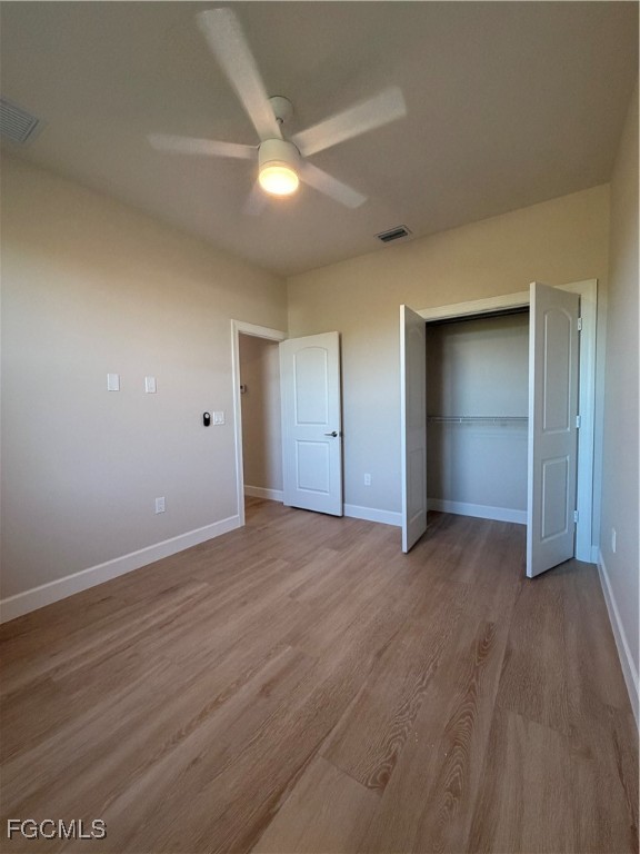 101 Pennfield Street Lehigh Acres, FL 33974 - Photo 24 of 29 a view of an empty room with wooden floor and closet