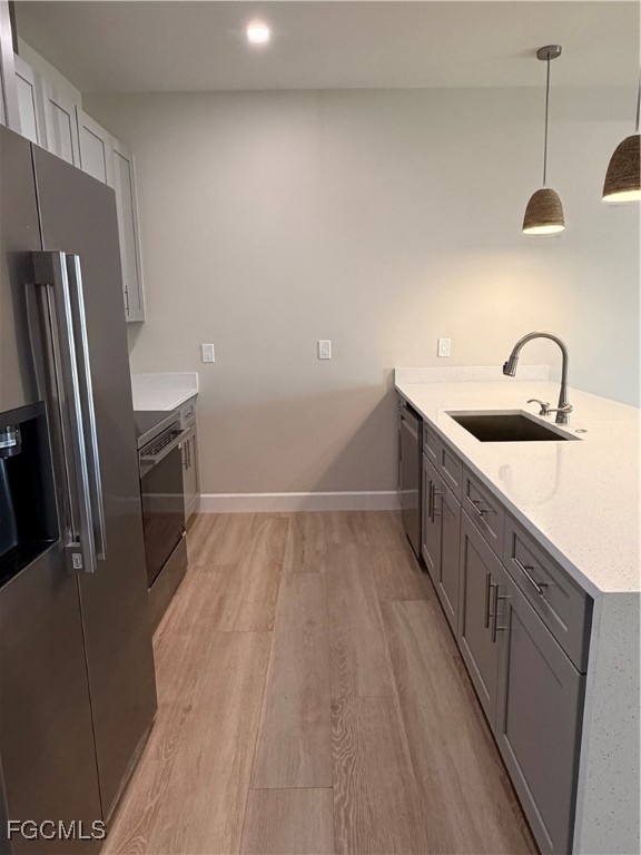 101 Pennfield Street Lehigh Acres, FL 33974 - Photo 5 of 29 a kitchen with stainless steel appliances a sink stove and refrigerator