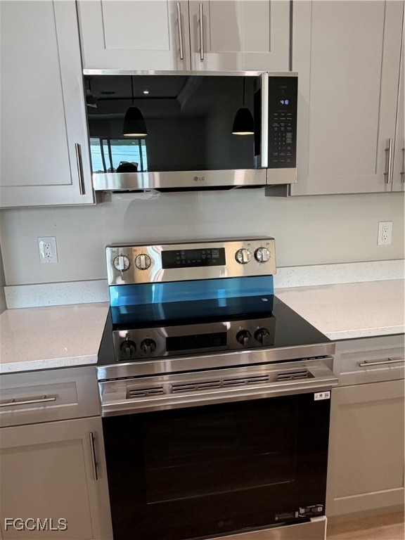 101 Pennfield Street Lehigh Acres, FL 33974 - Photo 6 of 29 a stove top oven sitting inside of a kitchen