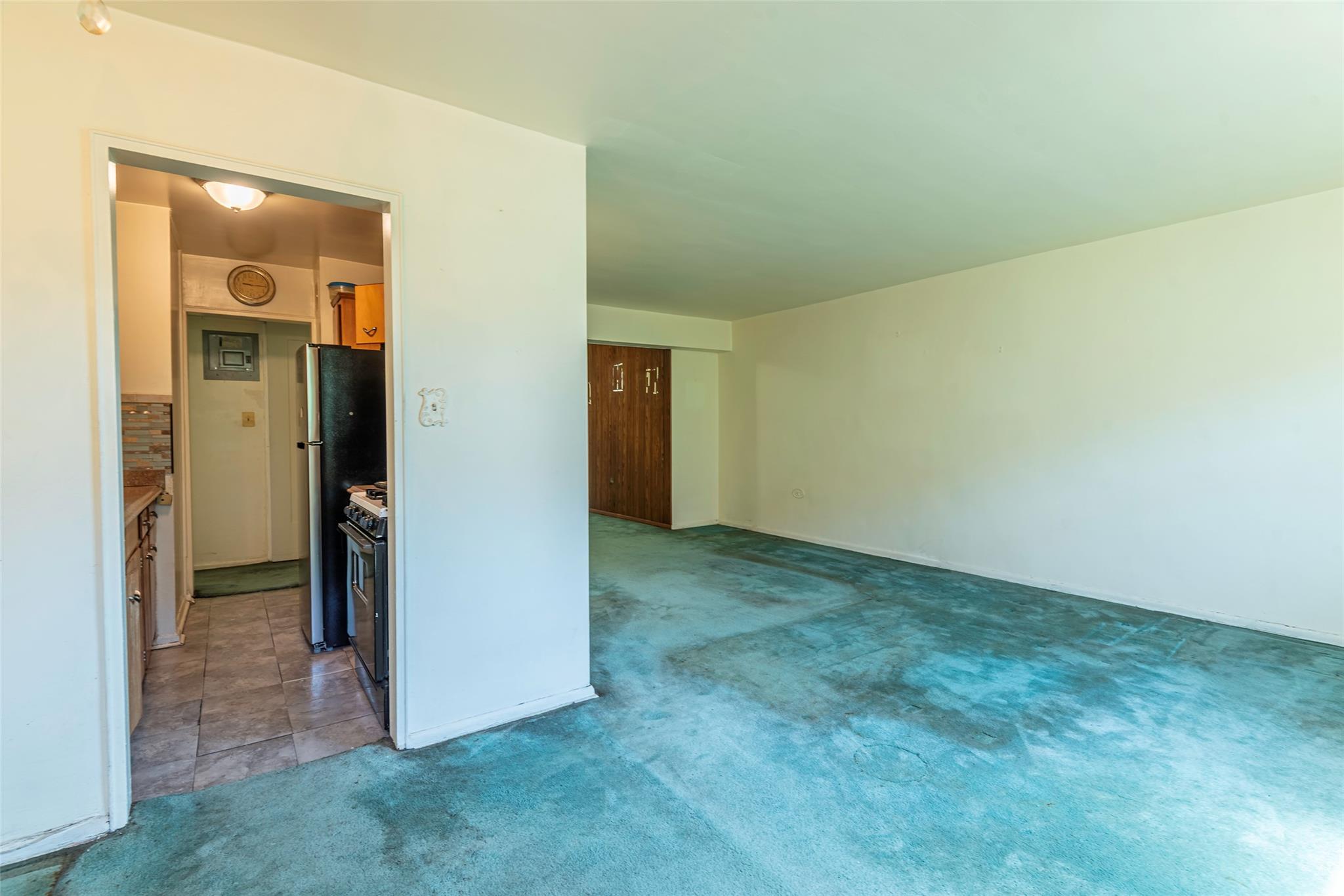 99-35 59th Avenue, Unit 4K Queens, NY 11368 - Photo 11 of 24 Carpeted spare room with baseboards