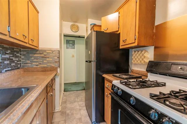 a kitchen with stainless steel appliances granite countertop a stove and a refrigerator