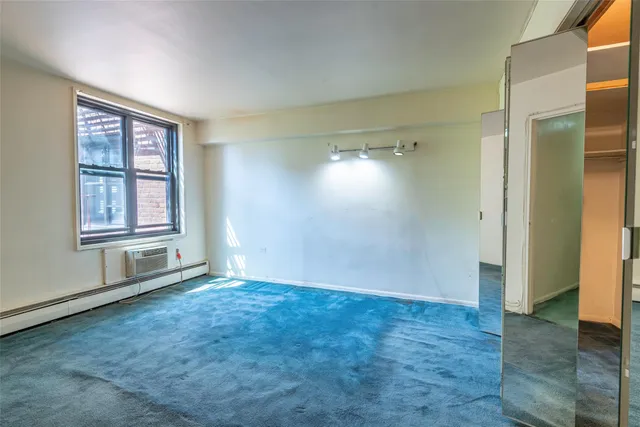 an empty room with windows and closet