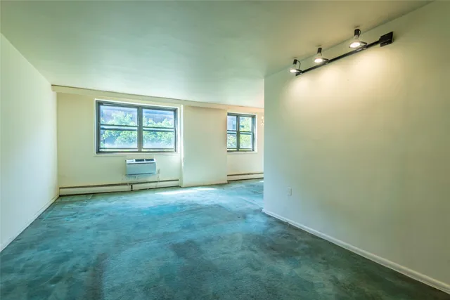 an empty room with a empty space and windows