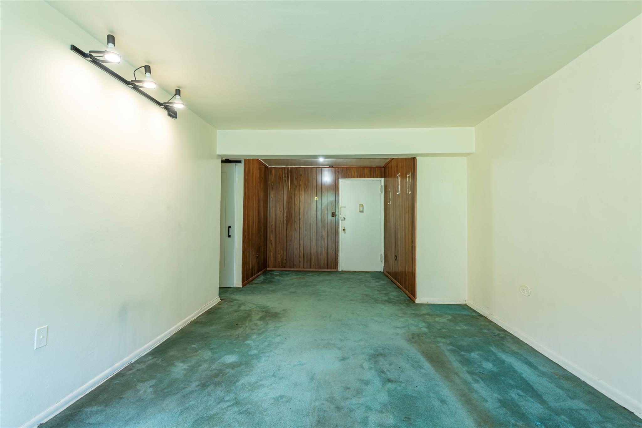 99-35 59th Avenue, Unit 4K Queens, NY 11368 - Photo 10 of 24 Carpeted spare room featuring baseboards