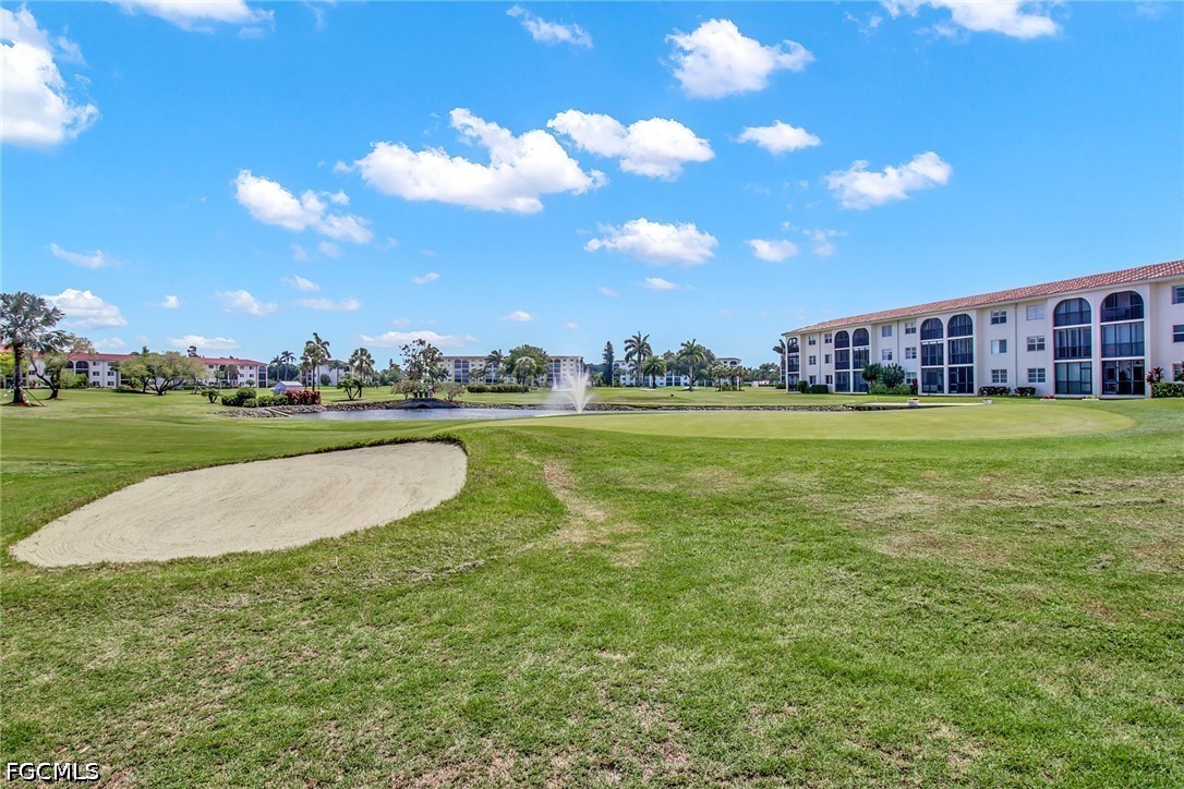 9 High Point Circle North, Unit 101 Naples, FL 34103 - Photo 45 of 49 a view of a swimming pool and a yard