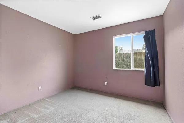 an empty room with closet area