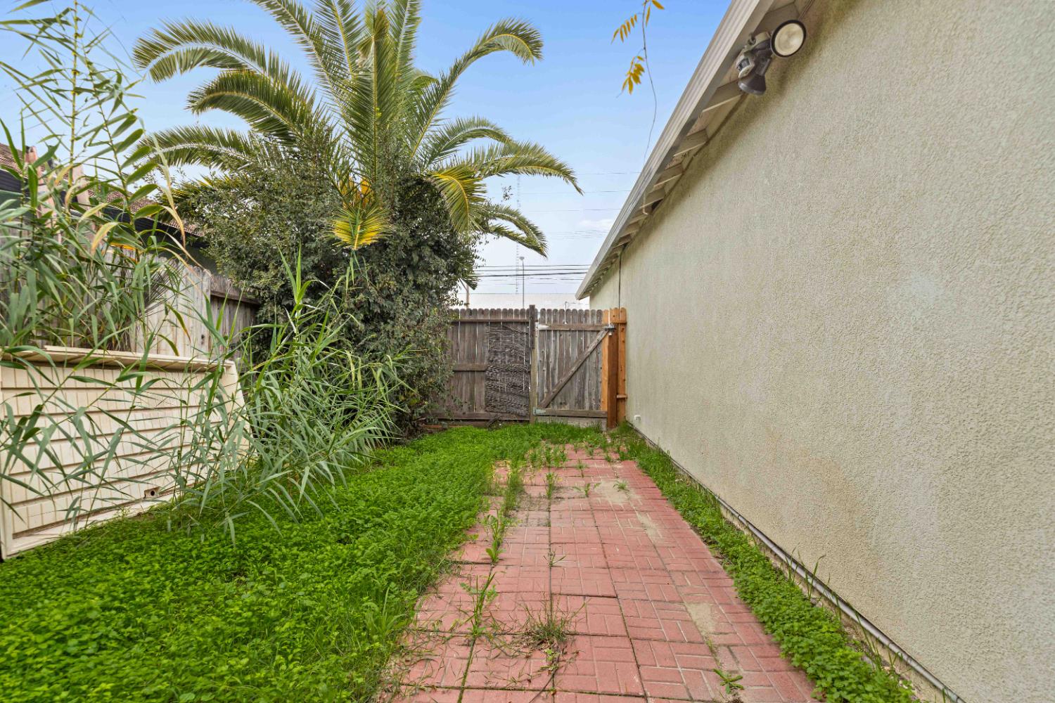 310 West F Street Turlock, CA 95380 - Photo 18 of 27 a view of a pathway both side of the house